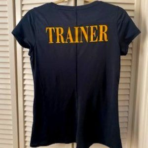 Size Medium Under Armour black shirt - Gold's Gym logo front; "Trainer" on back